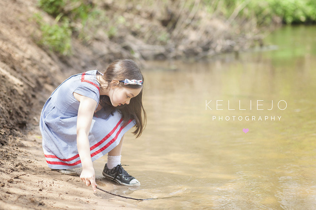 Portrait of a little girl playing in a stream in Styal in Wilmslow