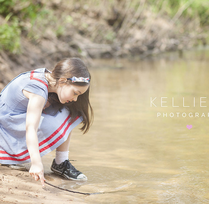 Portrait of a little girl playing in a stream in Styal in Wilmslow