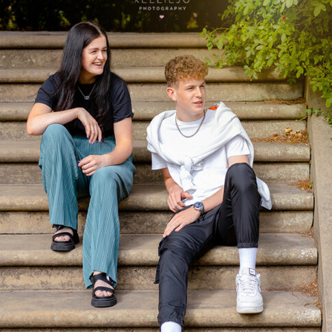 brother and sister sat on steps on photoshoot at Abney Hall in Cheadle