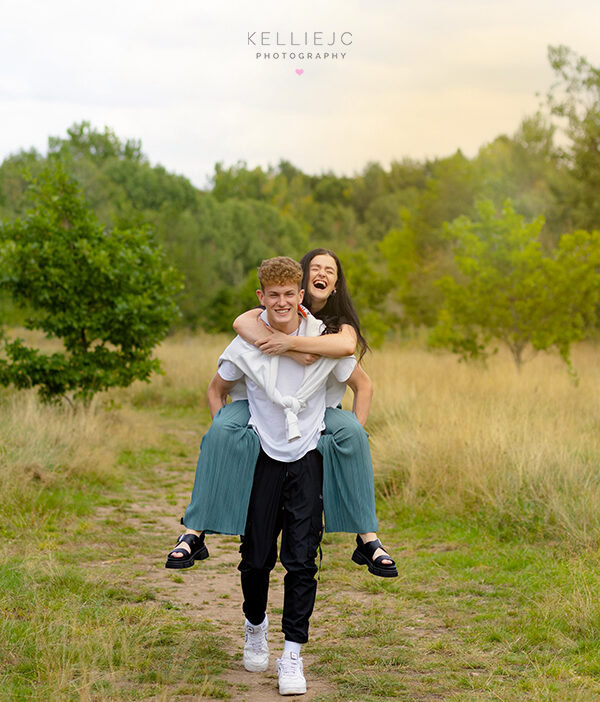 brother giving his sister a piggy back ride at Abney Hall in Cheadle