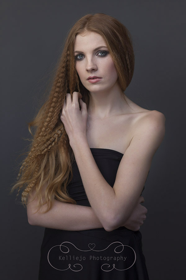 Modern portrait of a teenager with long ginger crimped hair