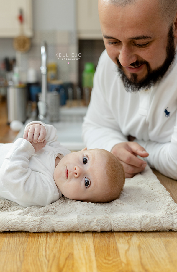 newborn with her daddy during an at home newborn family photoshoot