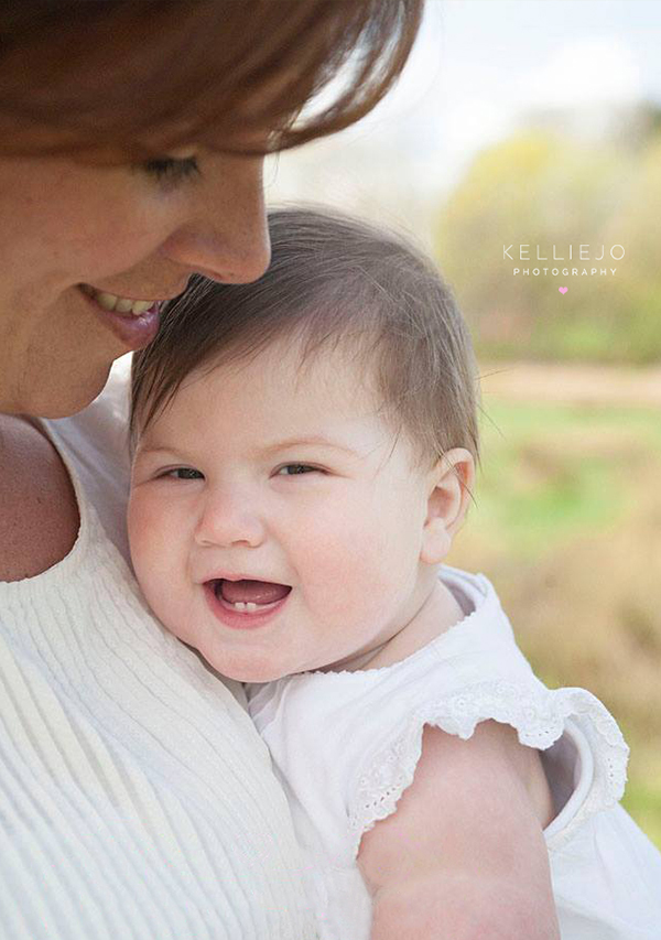 mother and daughter snuggling during an outdoor photoshoot
